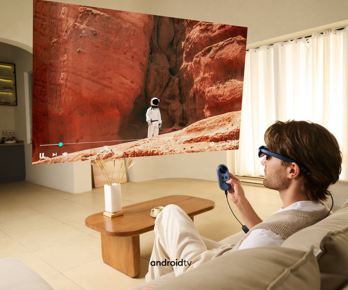 A man using Rokid Max AR glasses and Rokid Station Android tv box