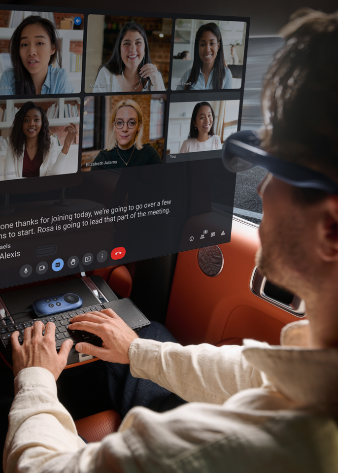 A man using Rokid Max Android glasses and Rokid Station Android TV box for work in a car