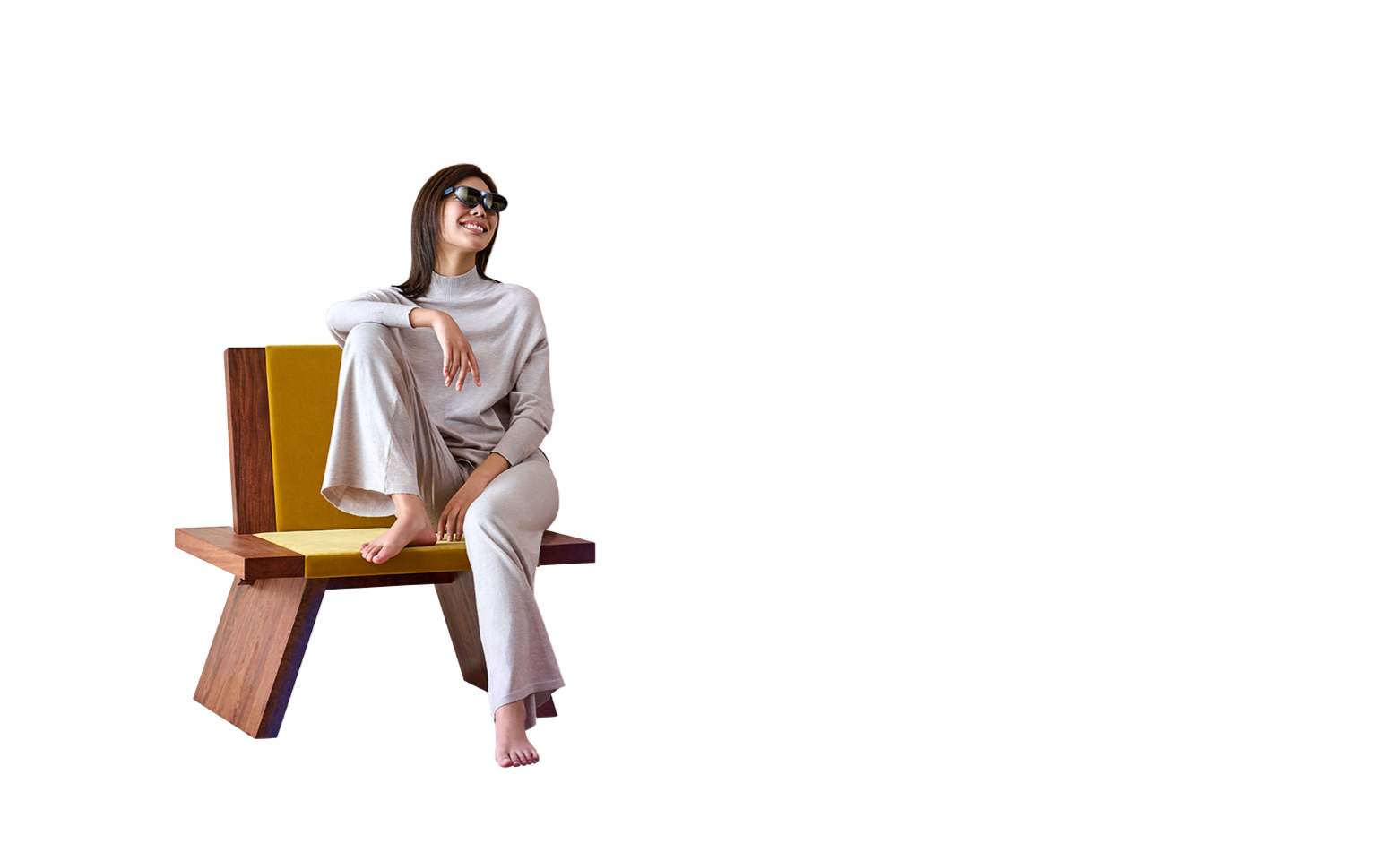 A woman wearing Rokid Max AR glasses sitting on a chair