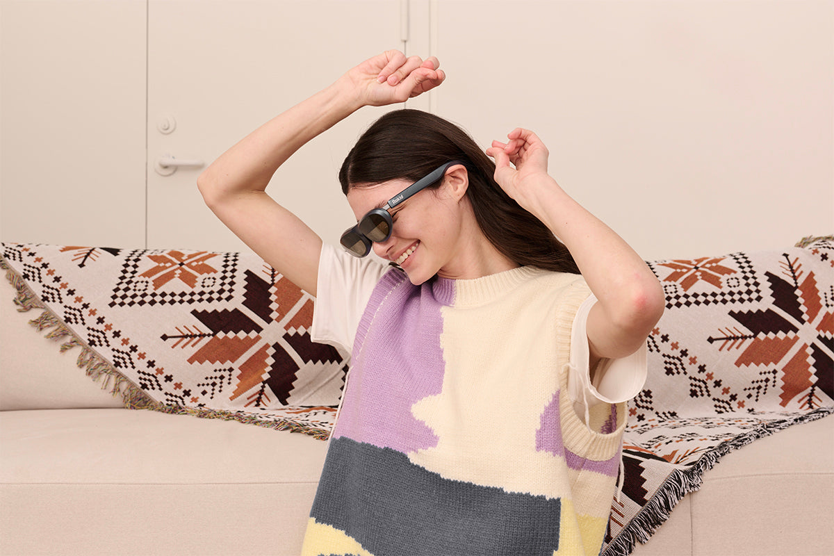 a woman wearing Rokid Max screen glasses happily